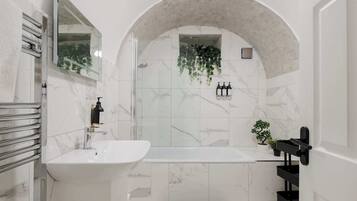 Bathtub, eco-friendly toiletries, hair dryer, towels