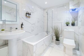 Bathtub, eco-friendly toiletries, hair dryer, bidet