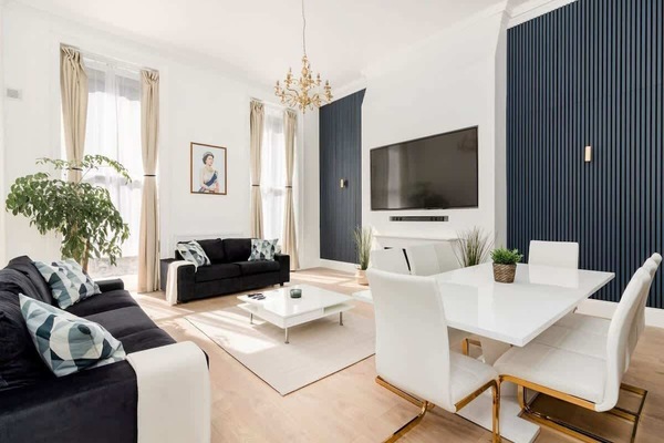 Relax in our elegant, spacious living room with air-con and 90-inch Smart LED TV