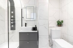 Bathtub, eco-friendly toiletries, hair dryer, towels