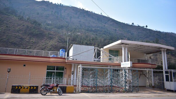 A building with a sign labeled "Guest House" and a motorcycle parked in front. - AJK Guest House (Mekhtar)