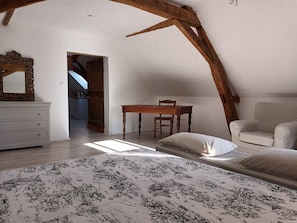 A bedroom with a bed, a dresser, a chair, and a table. - La chouett'chambre" bed and breakfast (Les Hermites)