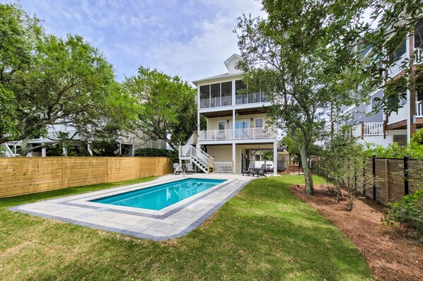 A two-story house with a pool, wooden deck, and a fenced backyard. - Sunset Oasis - Private Pool & Stunning Sunsets! (Surf City)