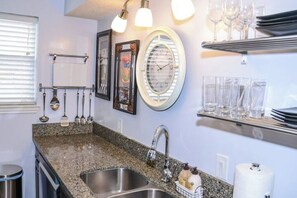 A kitchen with granite countertops, stainless steel sink, and overhead lighting. - I22 - Apt|Yard|11mi to Fair Park|Sleeps 4 (Irving)