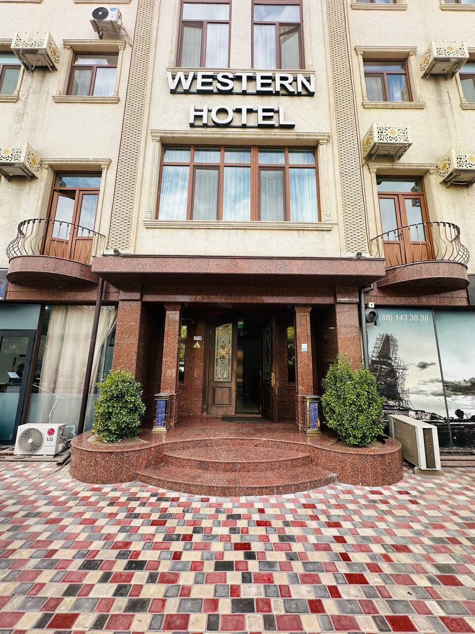 The Western Hotel facade with a checkered floor pattern and a central entrance.