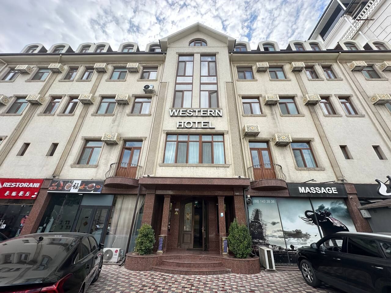 A Western Hotel with a central entrance, a massage service, and a restaurant.