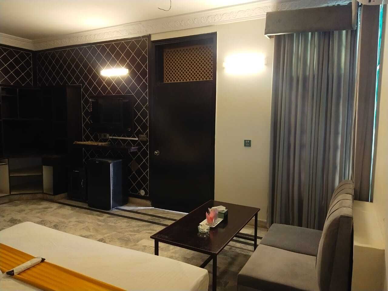 A compact living space with a kitchenette, a dining table, and a sofa.