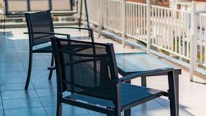 A rooftop terrace with two chairs and a table, offering a view of the cityscape. - Friendly Accommodation-GTD33701 (Athens)