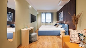 A modern bedroom with a bed, bedside tables, a mirror, a TV, and a window with curtains. - SWU Magazine Rooms (Budapest)