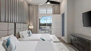 A hotel room with two beds, a TV, and a view of the outdoors. - Premium Home Near Disney w/ Speakeasy Lounge, Theater, Builder Theme BR & Gym (Davenport)