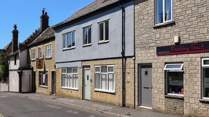 A row of two-story buildings with a hairdressing salon named "Finishing Touch" on the right. - Bahari (Lyme Regis)
