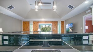A kitchen with a stainless steel range, a window with a view, and a ceiling fan. - Pozitively Bliss updated 3bed/2bath single family home near Sombrero Beach with private pool & dockage (Marathon)
