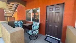 A cozy outdoor seating area with a staircase, a door with the number 2611, and a window with blinds. - Kings Court by Mesquite Vacation Rentals with Community Pool and $510 in free daily activities (Mesquite)