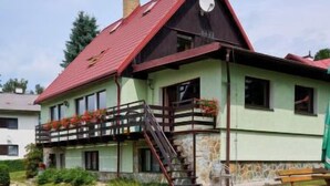 A house with a swimming pool, a wooden deck, and a red roof. - Harrachov Pool & Garden by Interhome (Harrachov)