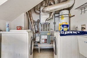 A laundry room with two washing machines, a dryer, and a water heater. - @ Marbella Lane - Home With Majestic Ocean Views (Pacifica)