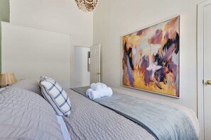 A hotel room with a bed, a painting, and a door. - @ Marbella Lane - Home With Majestic Ocean Views (Pacifica)