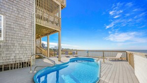 A pool on a wooden deck with a view of the ocean. - Soundfront Home with Private Pool, Hot Tub, and Private Windsurfing Access (Waves)