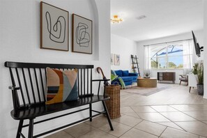 Relax in this stylish living room with a sofa, side table, and beautiful views of the outdoors.