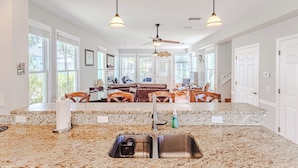 A kitchen with granite countertops, a stainless steel sink, and pendant lighting. - Mermaid's Rest Steinhatchee Landing Resort - Sleeps 6 (Steinhatchee)