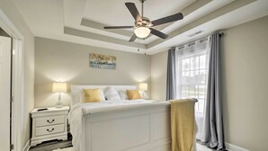 A bedroom with a bed, nightstands, a ceiling fan, a window with curtains, and a painting on the wall. - 3 Mi to Golf: Loris Home w/ Big Private Yard! (Loris)