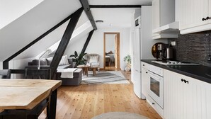 A loft-style apartment with a kitchen, dining area, and living space.