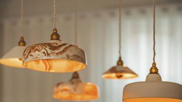 A series of pendant lights with a classic design, hanging from the ceiling in a well-lit room.