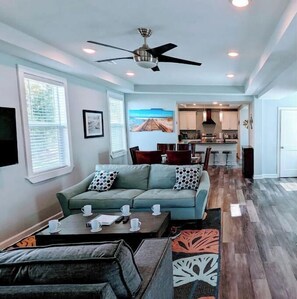 Relax in this inviting living space with a sofa, coffee table, and kitchen area.