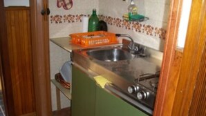 A compact kitchen with a sink, a stove, and a countertop. - Furnished mini-apartment (Bagni di Vinadio)