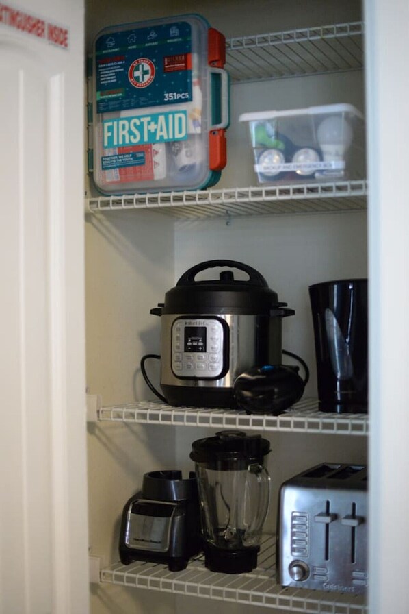 A kitchen with a first aid kit, a slow cooker, a blender, and a toaster. - Heated Pool | Pet Friendly | Beach Gear | Big Yard (Englewood)