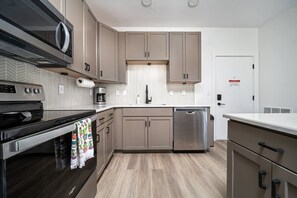 Fridge, microwave, oven, stovetop - NEW Slabtown Suites on Front Street Unit 303 (Traverse City)