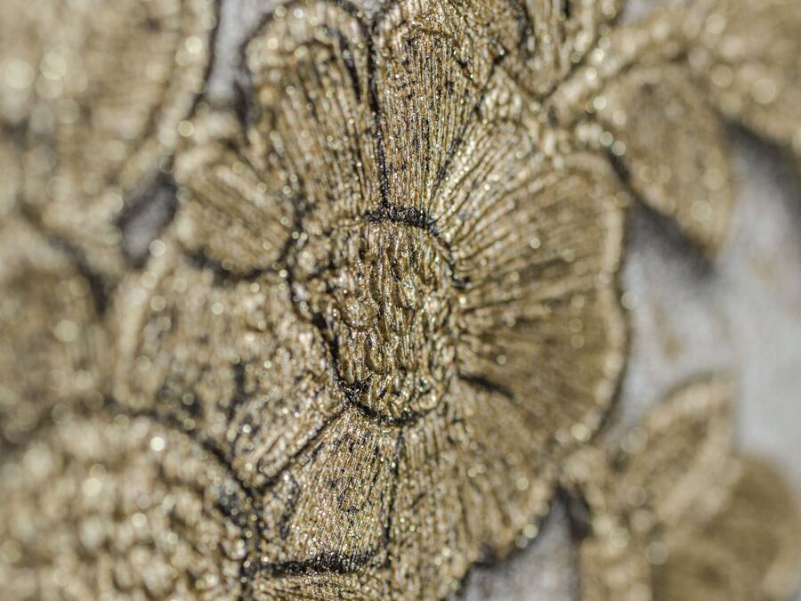 A close-up of a textured fabric with a floral pattern.