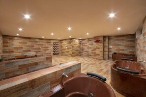 A spa area with a wooden reception desk, multiple seating areas, and a shower with a tiled wall. - Pistachio Hotel Sapa (Sa Pa)