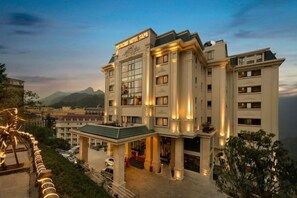 A multi-story hotel with a prominent entrance, large windows, and a sign indicating it is a hotel. - Pistachio Hotel Sapa (Sa Pa)