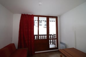 Enjoy the view from the balcony with a sliding glass door leading to a spacious seating area.