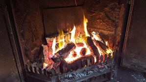 A fireplace with burning logs and flames. - The Stables at The Black Horse (Crook)