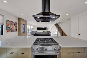 Enjoy cooking in this well-equipped kitchen with a large island and stainless steel appliances.