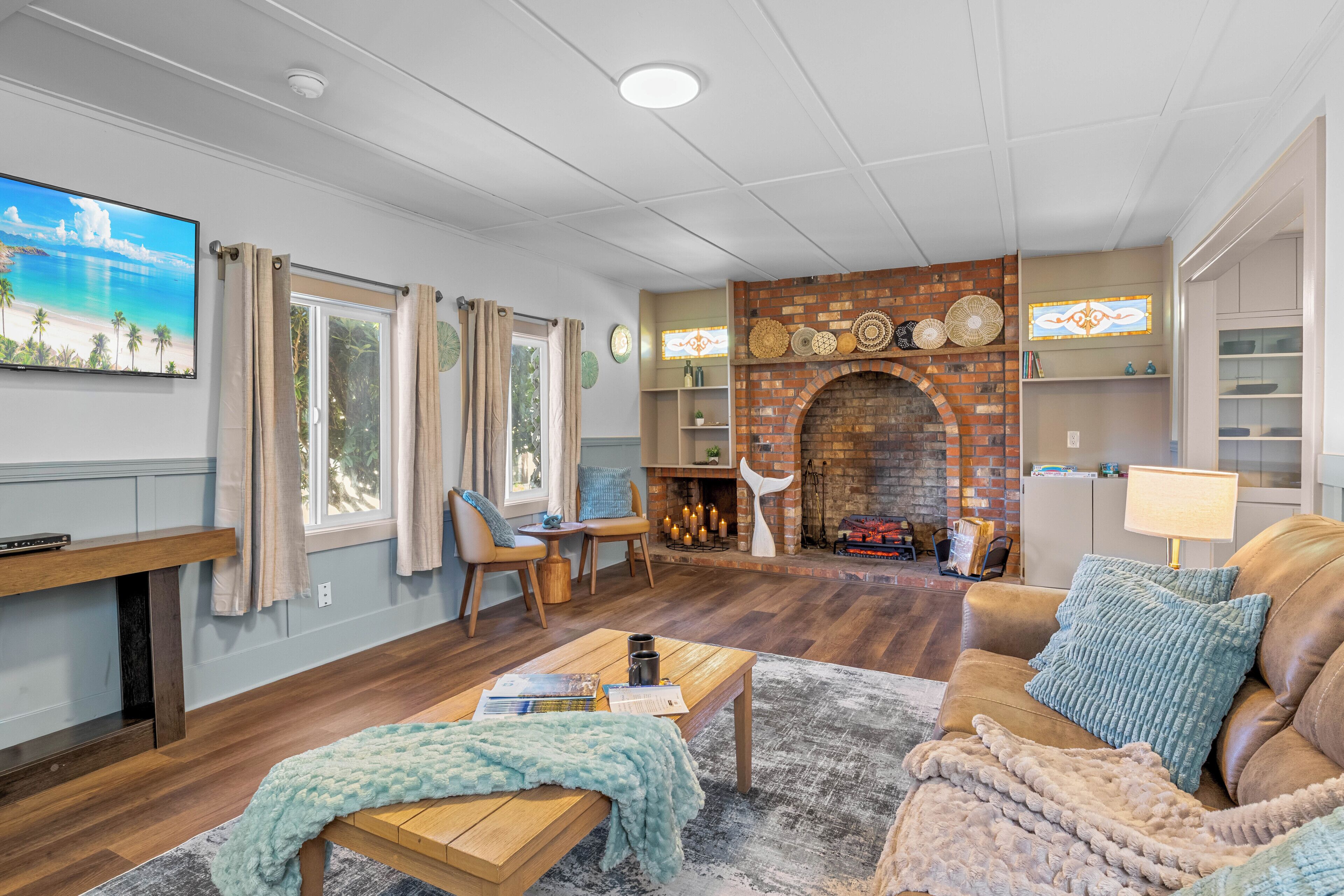 A living room with a fireplace, wooden furniture, and a television.