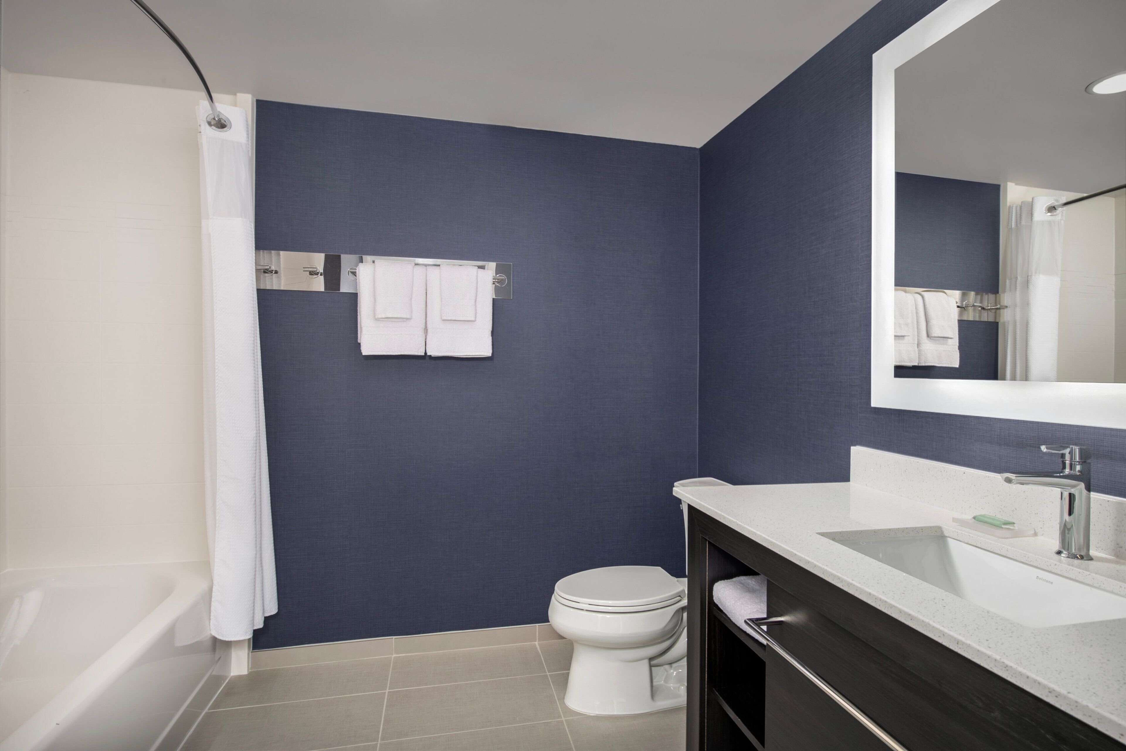 A bathroom with a bathtub, toilet, and sink.
