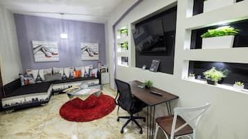 Junior Room, 1 Queen Bed | Living area | 32-inch LED TV with cable channels, TV