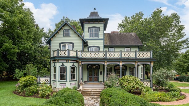 A large, two-story house with a wrap-around porch, a tower, and a well-maintained garden. - Magnolia House estate - family reunions, micro-weddings, retreats. (Hot Springs)