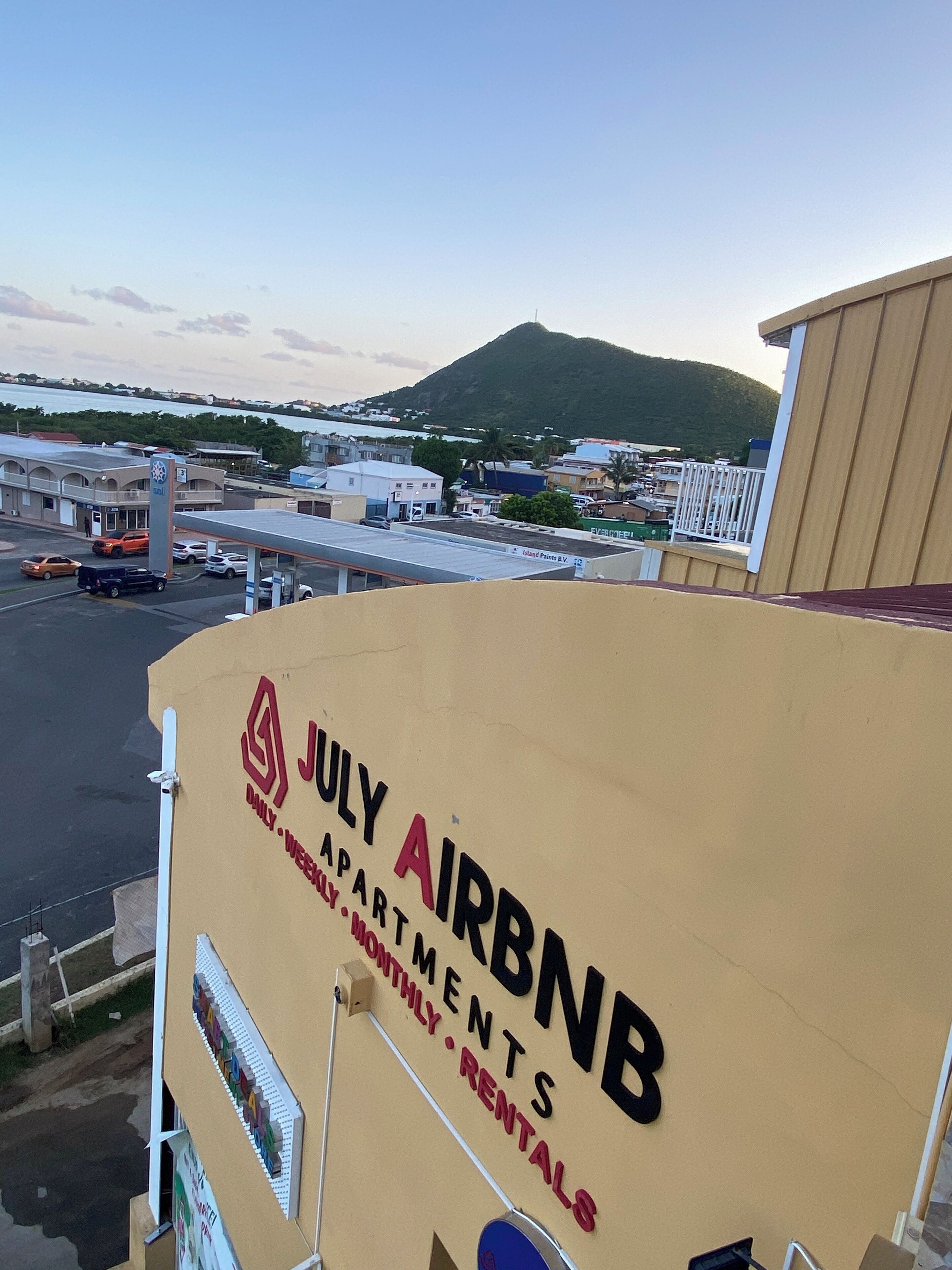 A building with a sign for 'JULY AIRBNB' indicating it offers apartments and rentals.