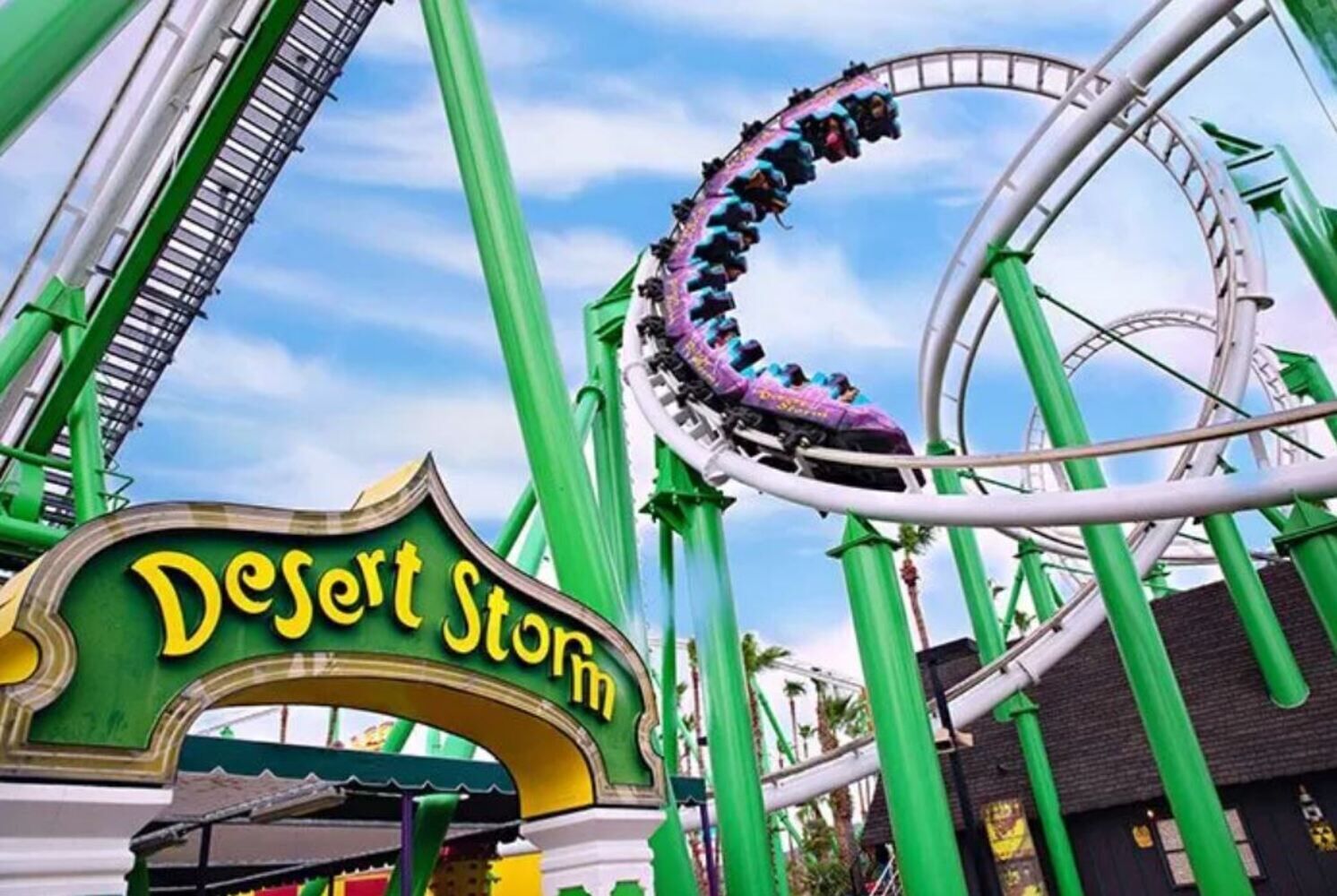 A roller coaster at a theme park with a sign reading "Desert Storm".