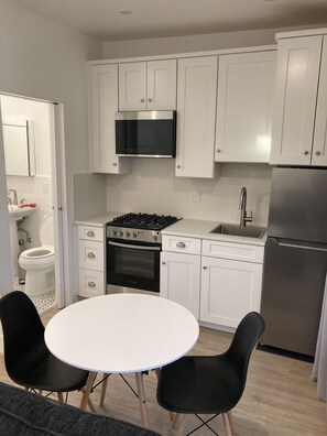 Fridge, microwave, coffee/tea maker, cookware/dishes/utensils