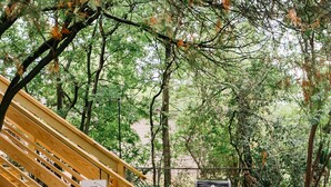 A wooden staircase leading to a bench with a sign reading "THE HURST PLAY". - Historic 5/4 • Spacious • Sleeps 16 • Hot Tub • Pool • A&M (Bryan)
