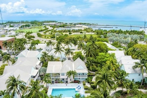 A resort with multiple buildings, a swimming pool, and a view of the ocean. - A Siesta Bay by Avantstay Key West Walkable Gated Community, Shared Pool Month-long Stays (Key West)