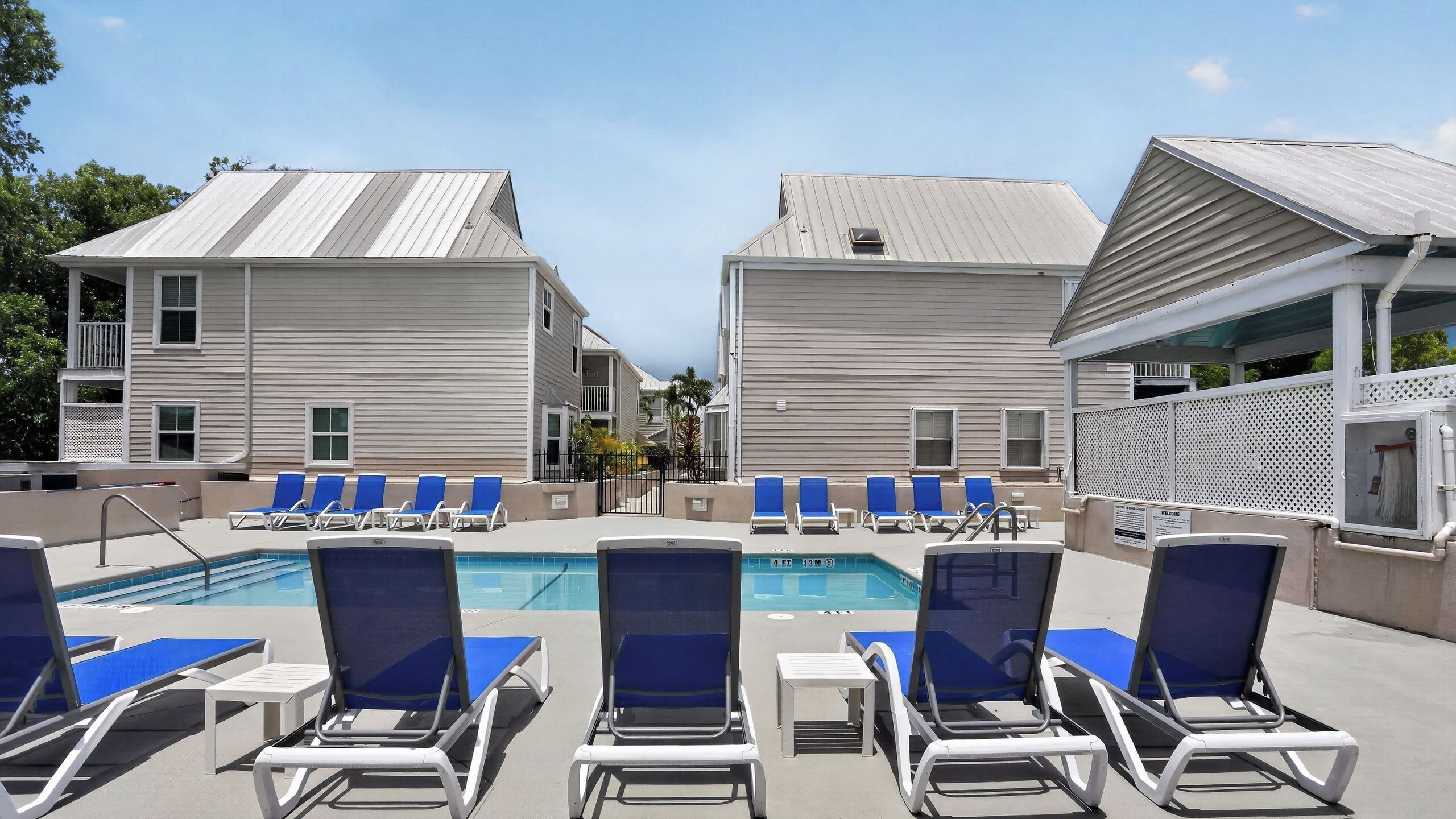 A pool area with lounge chairs and a swimming pool.
