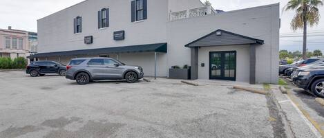 A two-story building with a parking lot in front.