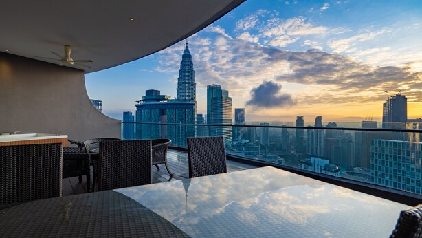 A rooftop terrace with a panoramic city view, including a prominent skyscraper. - THE PENTHOUSE KLCC (Kuala Lumpur)