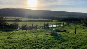 A rural landscape with a fence, a small pond, and rolling hills in the background. - The Grainary Boutique Hotel (Scarborough)