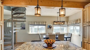 A kitchen with a granite island, a spiral staircase, and pendant lighting. - The View at Mountain Retreat By Red Rocks & Golden (Evergreen)